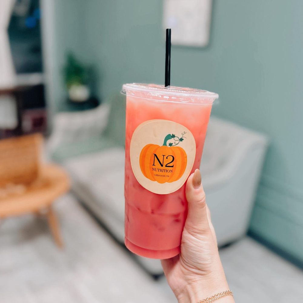 A pink N2 beauty tea held up in the shop
