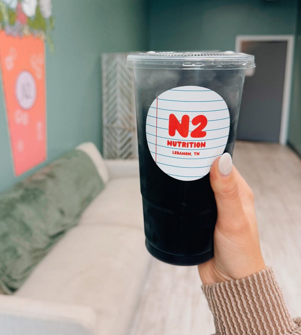 A dark blackberry N2 tea held up in the shop