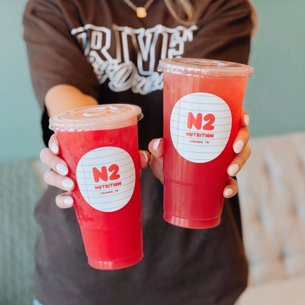 Two red N2 teas held up