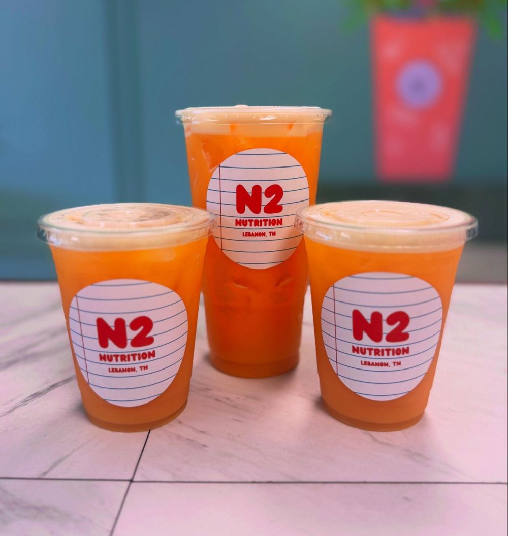 Three orange N2 teas on the counter